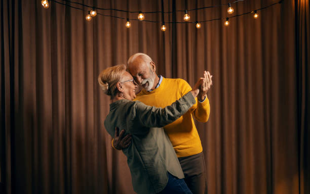 A happy affectionate couple is dancing together.