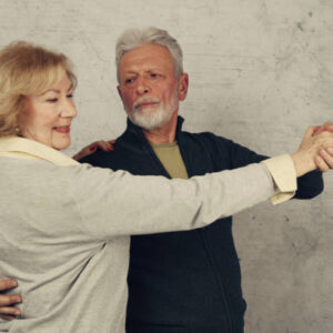 Happy stylish elderly couple dancing and laughing. vintage image