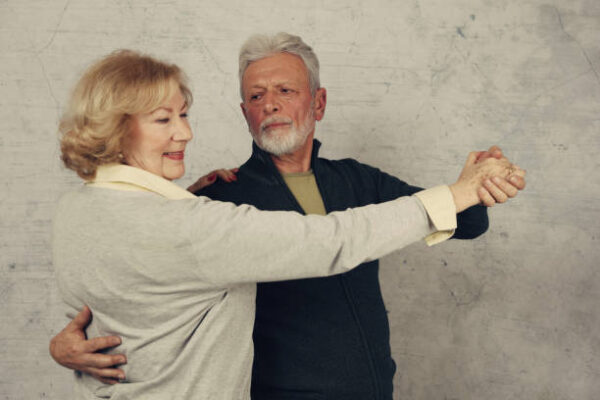 Happy stylish elderly couple dancing and laughing. vintage image
